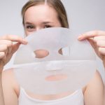 Woman unfolding of the Mira-Skin Mask before use