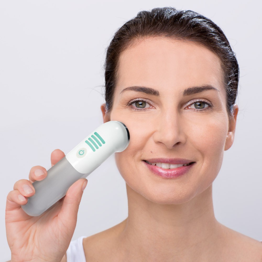 Woman using Use the Mira-Skin ActiveBooster wand for skin rejuvenation in her face
